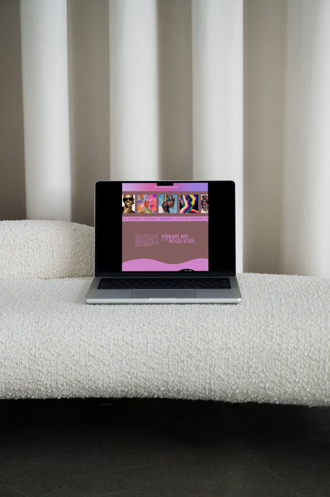 Foxxy Kay Studios shop page on a laptop with vibrant art prints