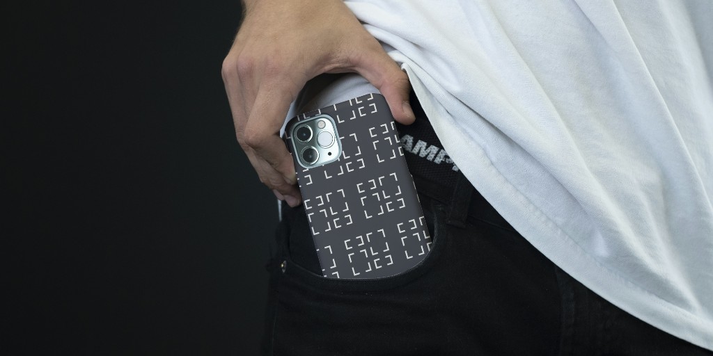 Phone with Ionize Studios patterned case sliding into a pocket